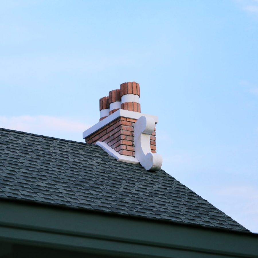 chimney-on-house-roof-closeup-blue-sky-background-2023-11-27-05-07-13-utc