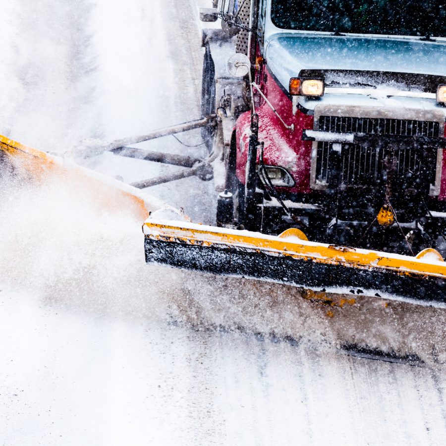 Snowplow Truck Removing the Snow from the Highway during a Cold Snowstorm Winter Day